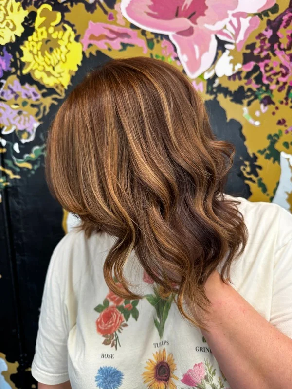 Woman with freshly cut and styled mid-length hair.